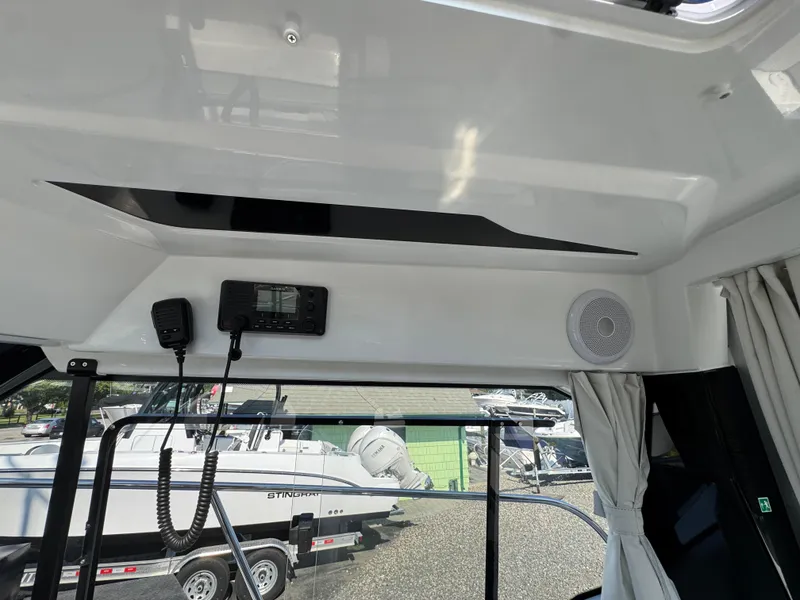 Slide: The Image of Interior view of 2025 Jeanneau NC 795 Series 2 boat, featuring communication equipment and speaker. - 11