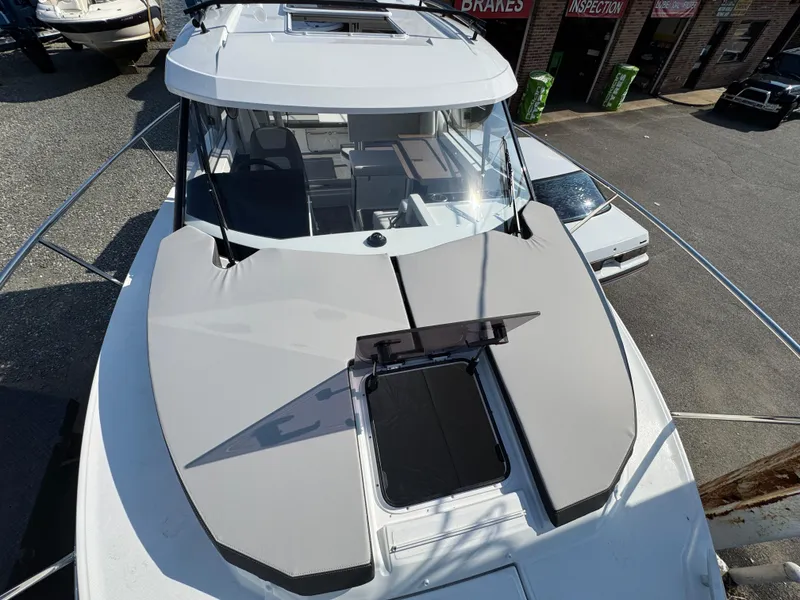 Slide: The Image of 2025 Jeanneau NC 795 Series 2 boat, top view, docked in a marina. - 21