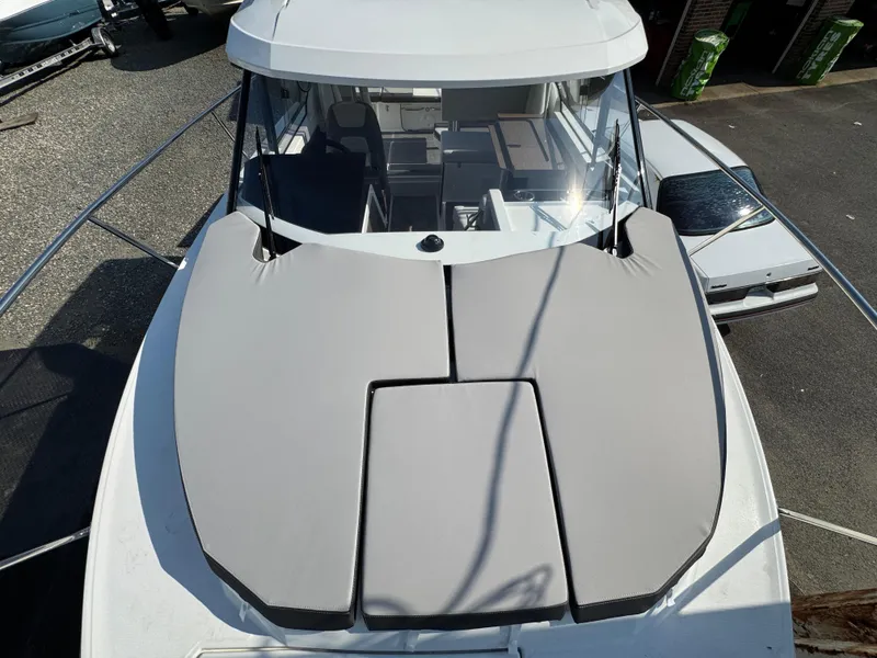 Slide: The Image of 2025 Jeanneau NC 795 Series 2 boat with cushioned deck, docked outdoors. - 22
