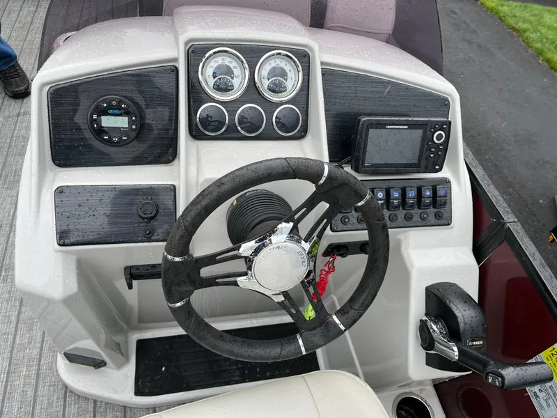Slide: The Image of 2021 Sylvan Mirage X X3 boat dashboard with steering wheel and control panel. - 10