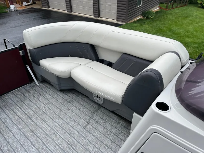 Slide: The Image of 2021 Sylvan Mirage X X3 boat with gray and white seating on a textured deck. - 13