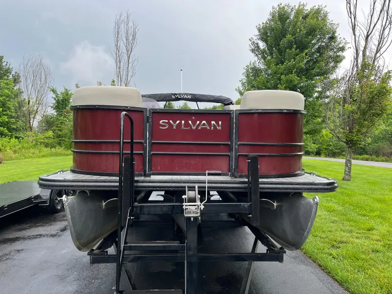Slide: The Image of 2021 Sylvan Mirage X X3 pontoon boat on trailer, parked on a driveway. - 16
