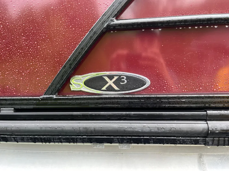 Slide: The Image of Close-up of 2021 Sylvan Mirage X X3 logo on a wet red surface. - 4
