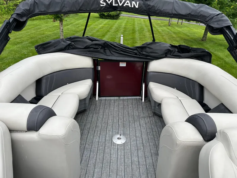 Slide: The Image of 2021 Sylvan Mirage X X3 pontoon boat interior with gray seating and carpet. - 6