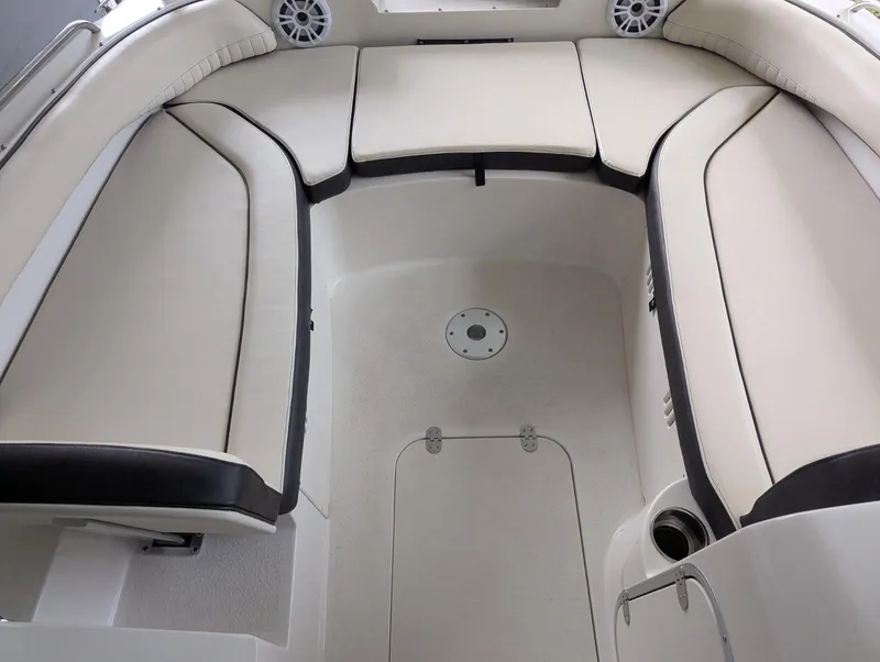 Slide: The Image of 2021 Stingray 192 SC boat interior with beige seating and speakers. - 2