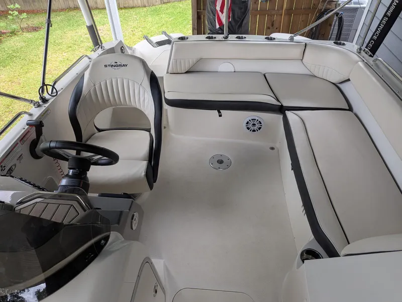 Slide: The Image of 2021 Stingray 192 SC boat interior with white seating and steering wheel. - 5
