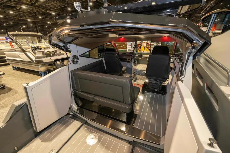 Slide: The Image of 2024 G-Force boat interior with sleek seating and modern design at a showroom. - 10