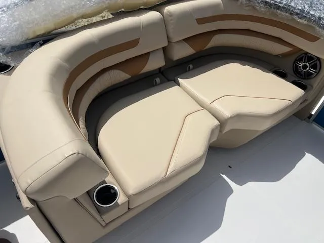Slide: The Image of 2025 Hurricane FunDeck 2360 SBC OB boat seating with beige upholstery and cup holders. - 10
