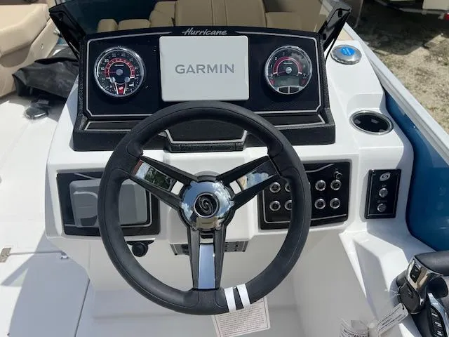 Slide: The Image of Steering console of 2025 Hurricane FunDeck 2360 SBC OB with Garmin display and controls. - 4