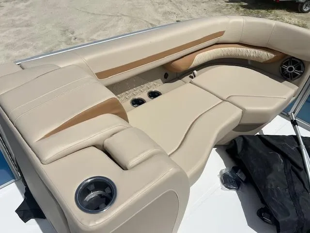 Slide: The Image of 2025 Hurricane FunDeck 2360 SBC OB boat interior with beige seating and cup holders. - 7