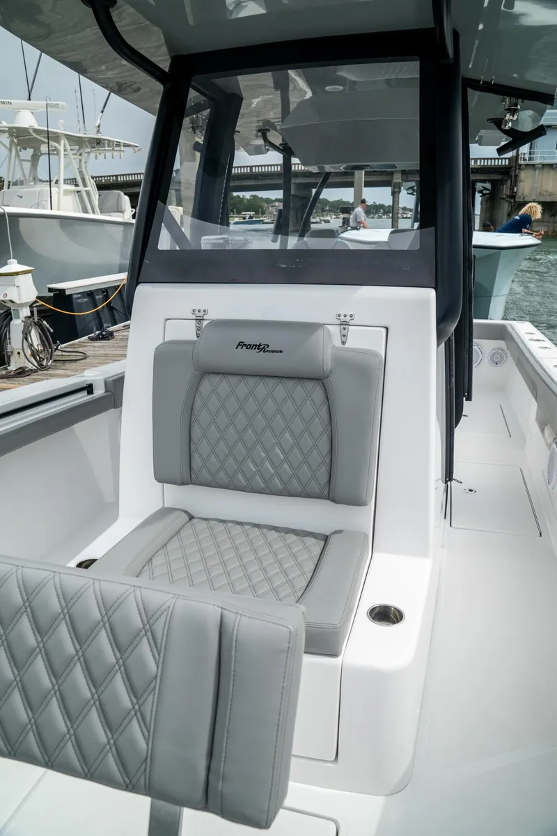 Slide: The Image of 2026 Front Runner 33 CC boat with luxurious gray seating and sleek design. - 12