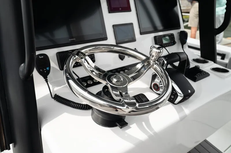 Slide: The Image of Steering console of 2026 Front Runner 33 CC boat with modern controls and displays. - 15