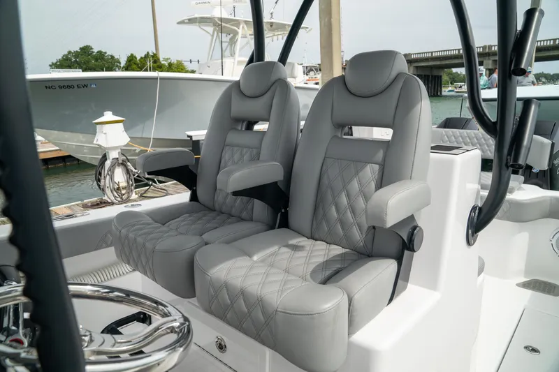 Slide: The Image of Luxury seating on 2026 Front Runner 33 CC boat, featuring plush gray upholstery. - 18