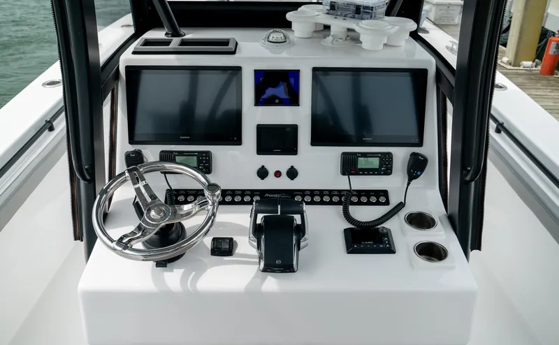 Slide: The Image of 2026 Front Runner 33 CC boat dashboard with dual screens and steering wheel. - 20