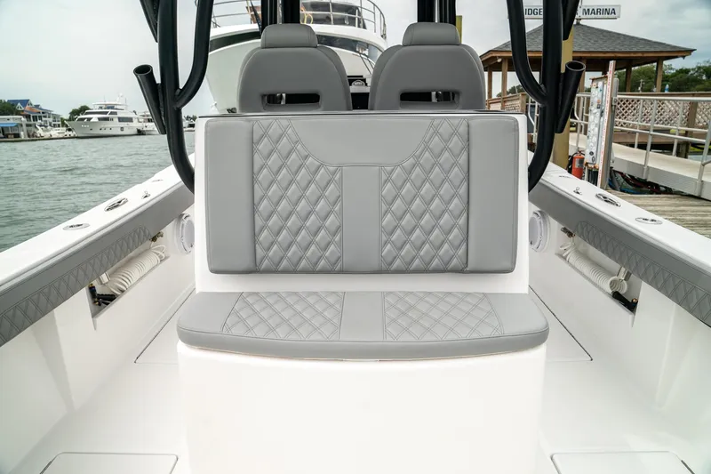 Slide: The Image of 2026 Front Runner 33 CC boat interior with gray quilted seating at marina. - 25
