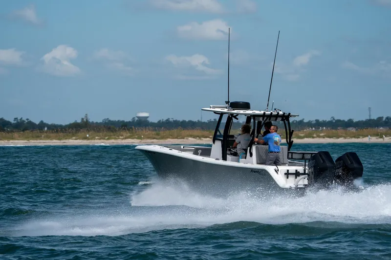 Slide: The Image of 2026 Front Runner 33 CC boat cruising on open water under a clear sky. - 4