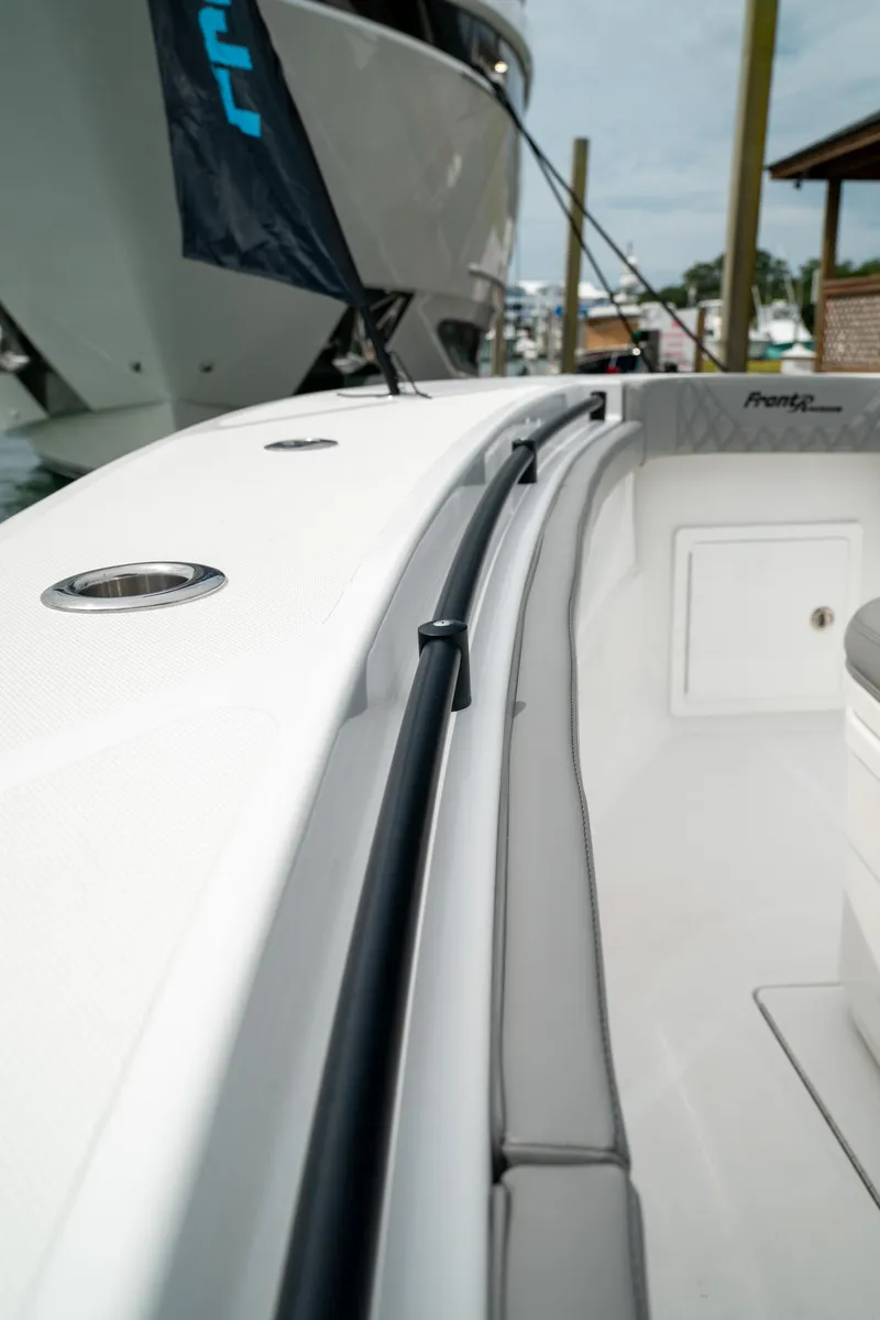 Slide: The Image of 2026 Front Runner 33 CC boat, sleek white deck, docked at marina. - 8