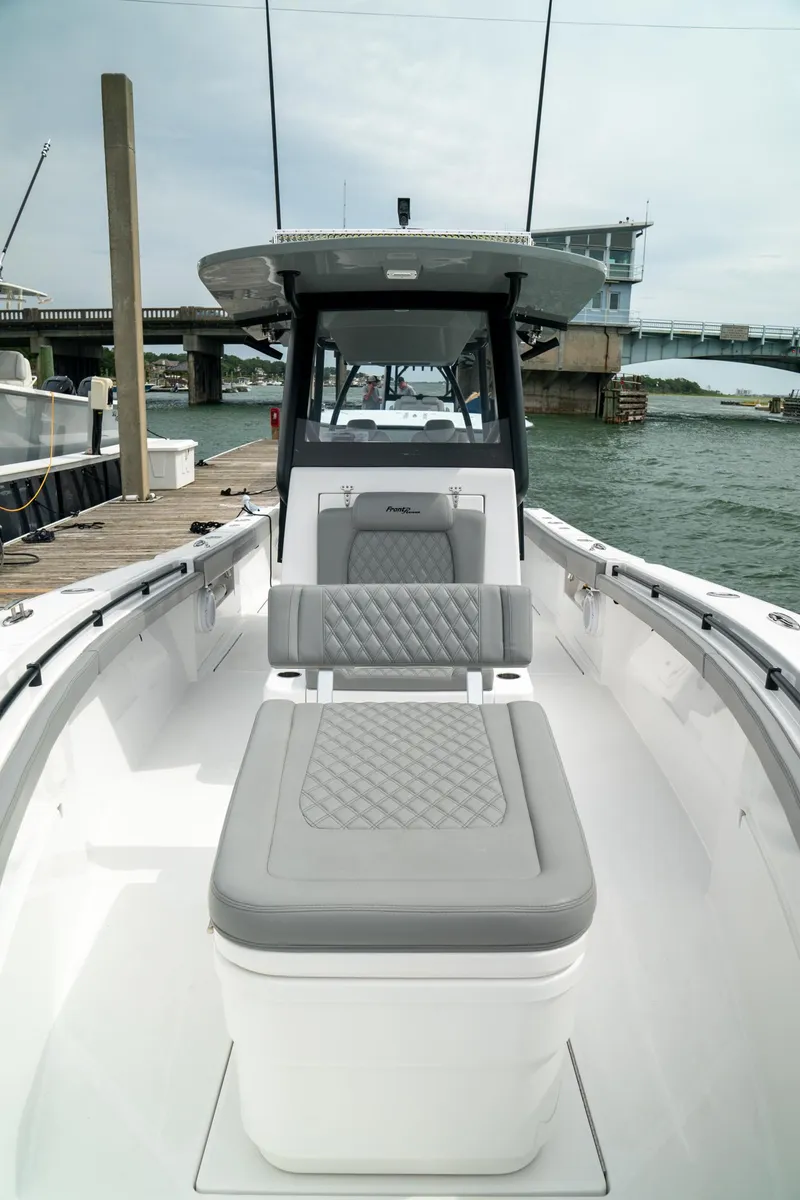 Slide: The Image of 2026 Front Runner 33 CC boat docked, featuring sleek seating and modern design. - 9