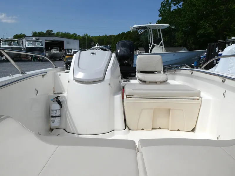 Slide: The Image of 2024 Boston Whaler 160 Super Sport boat interior with seating and storage. - 7