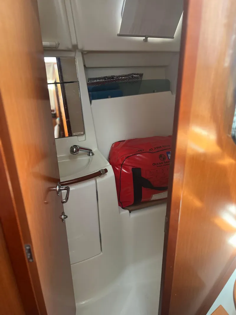 Slide: The Image of Interior of 2007 Beneteau Oceanis Clipper 343 yacht bathroom with sink and red bag. - 18