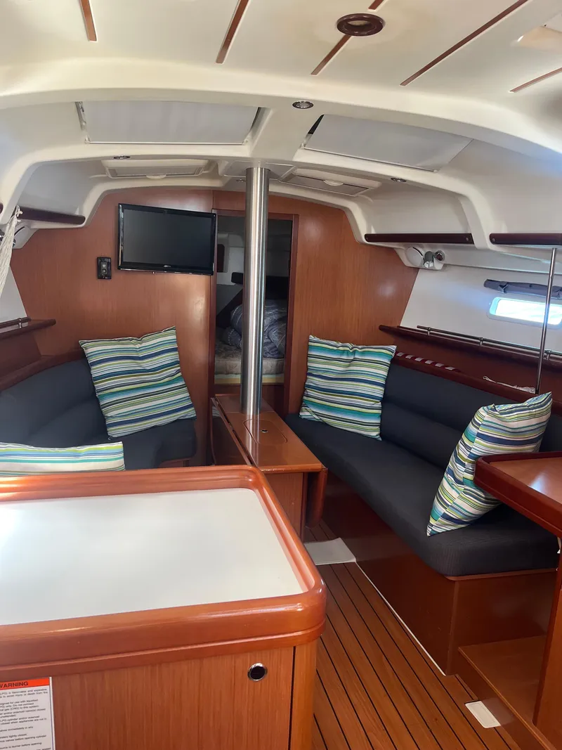 Slide: The Image of Interior of 2007 Beneteau Oceanis Clipper 343 yacht with cozy seating and striped cushions. - 24