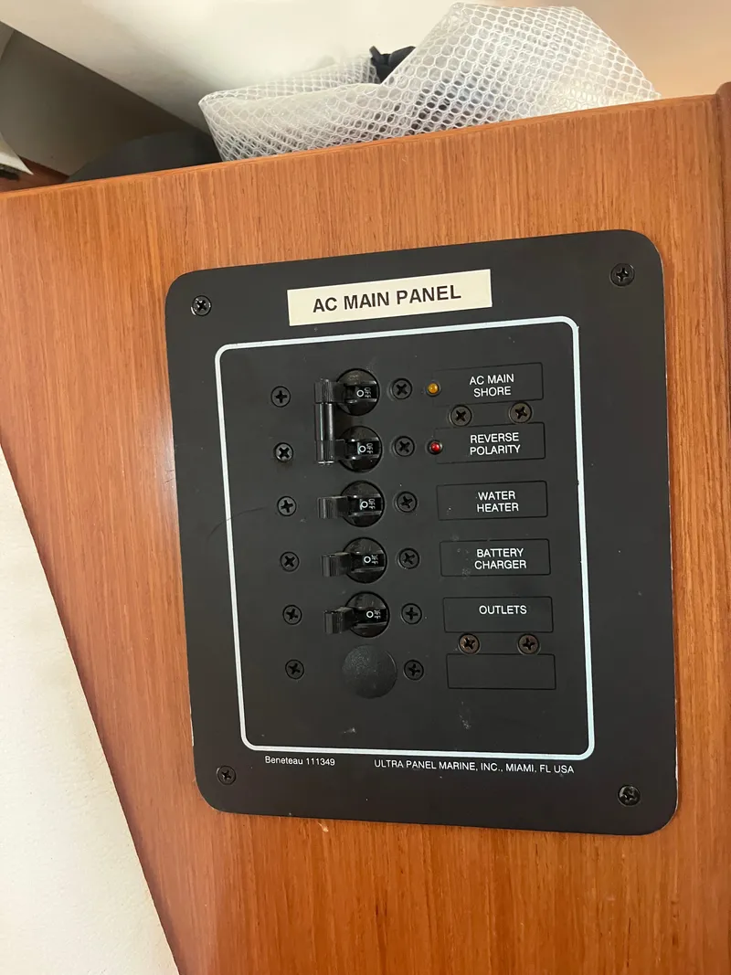 Slide: The Image of AC main panel on 2007 Beneteau Oceanis Clipper 343 yacht, featuring various electrical controls. - 44