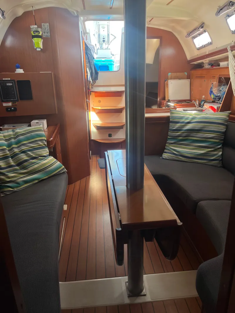 Slide: The Image of Interior of 2007 Beneteau Oceanis Clipper 343 sailboat with cozy seating and wooden finishes. - 45