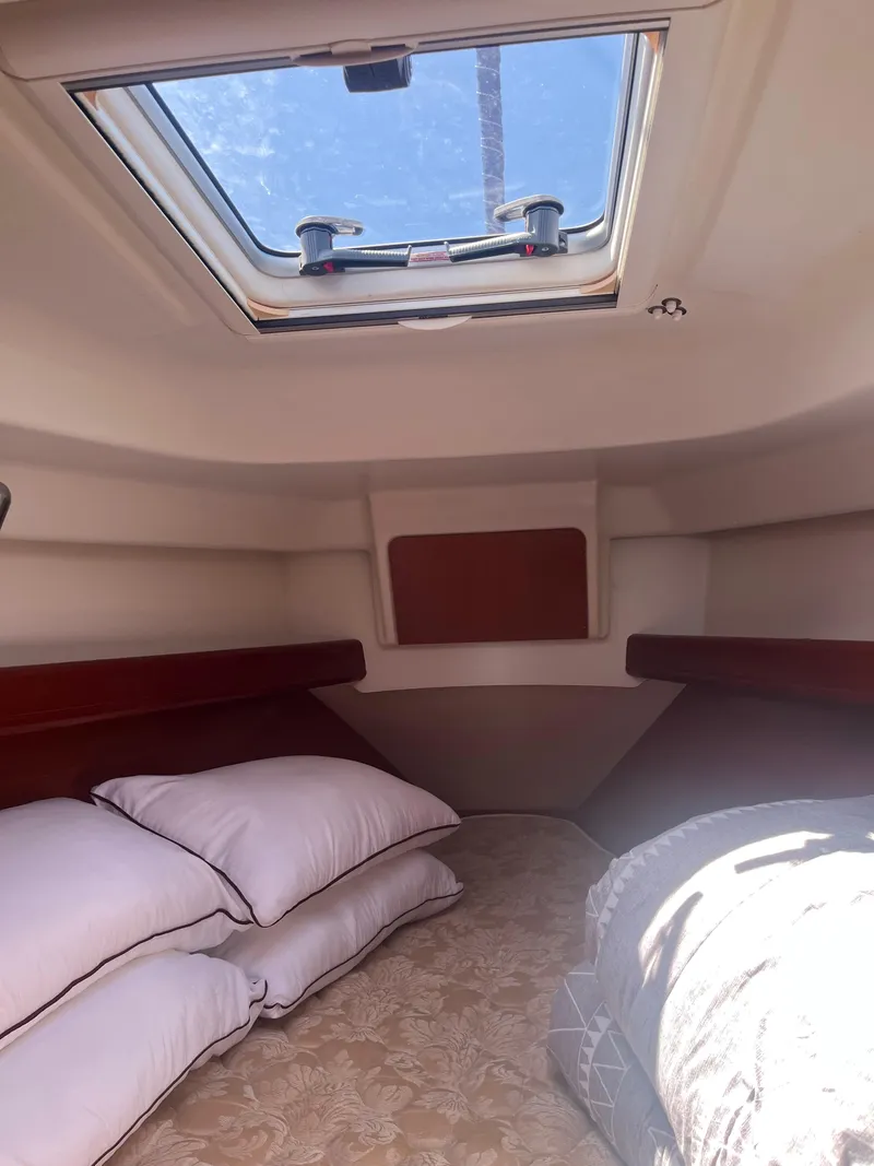Slide: The Image of Cozy cabin interior of 2007 Beneteau Oceanis Clipper 343 with skylight and bedding. - 46