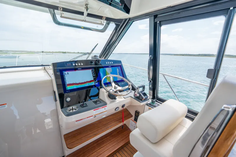 Slide: The Image of Interior view of 2026 Boston Whaler 405 Conquest cockpit with modern navigation. - 21
