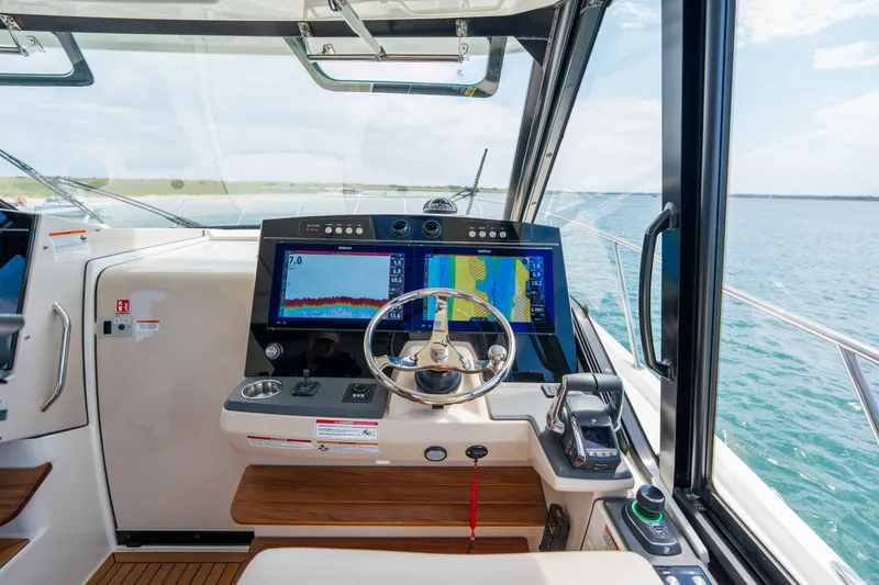 Slide: The Image of 2026 Boston Whaler 405 Conquest helm with navigation screens. - 23