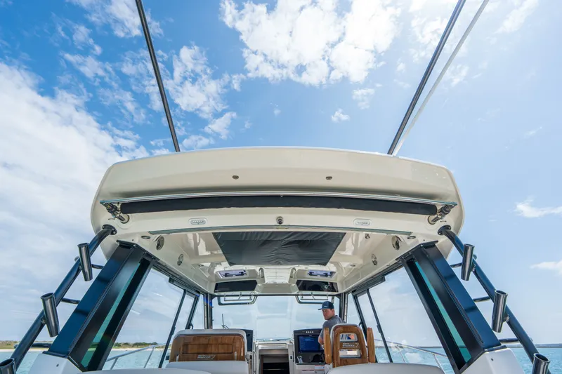 Slide: The Image of Boston Whaler 405 Conquest 2026 on open sea under blue sky. - 33