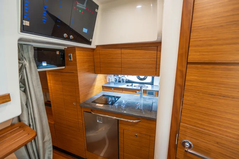 Slide: The Image of Interior of 2026 Boston Whaler 405 Conquest featuring modern kitchen. - 35