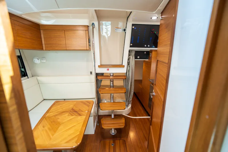 Slide: The Image of Interior of 2026 Boston Whaler 405 Conquest with wooden furnishings. - 41