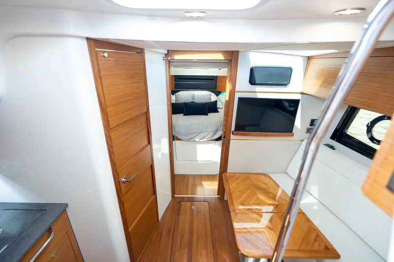 Slide: The Image of Interior of 2026 Boston Whaler 405 Conquest with wooden furnishings and bed. - 44