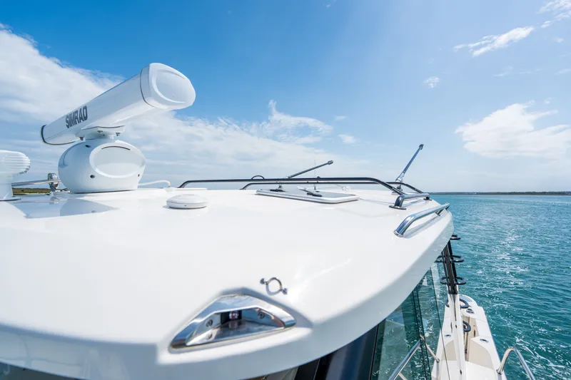 Slide: The Image of Boston Whaler 405 Conquest 2026 on open sea under clear sky. - 48