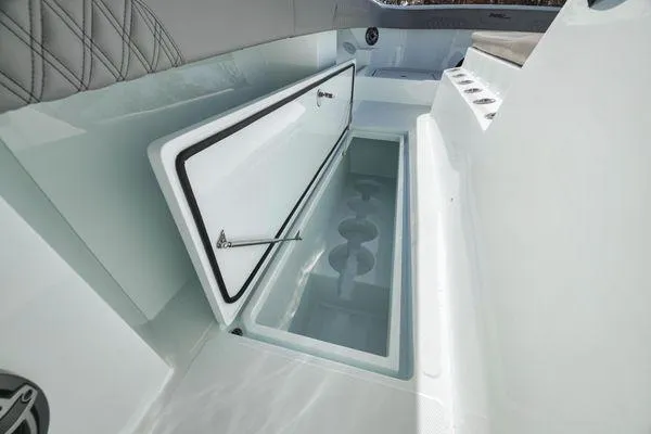 Slide: The Image of 2026 Front Runner 37 Cat boat storage compartment with open lid, showcasing spacious interior design. - 11
