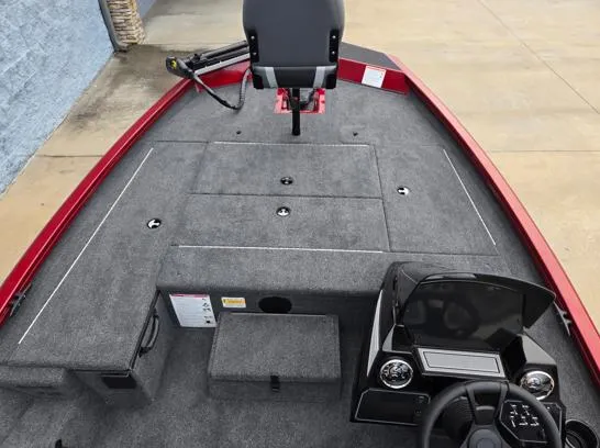 Slide: The Image of 2025 Lowe Stinger 175C boat interior with gray carpet and steering console. - 6