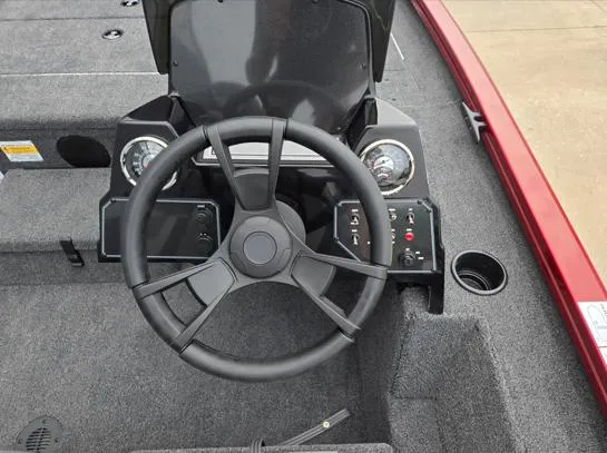 Slide: The Image of 2025 Lowe Stinger 175C boat dashboard with steering wheel and control panel. - 7