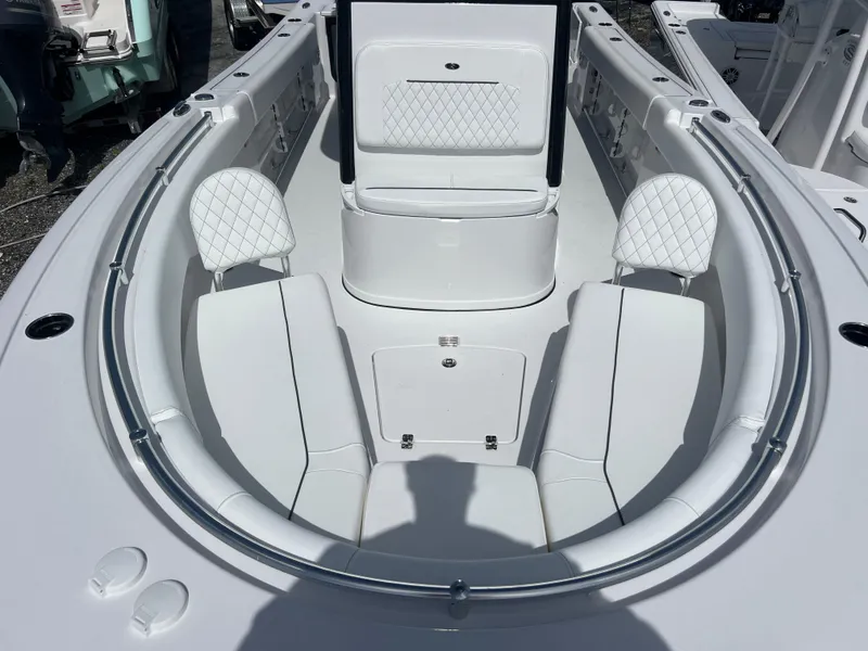 Slide: The Image of 2025 Sportsman Open 232 Center Console boat interior with cushioned seating and storage. - 12