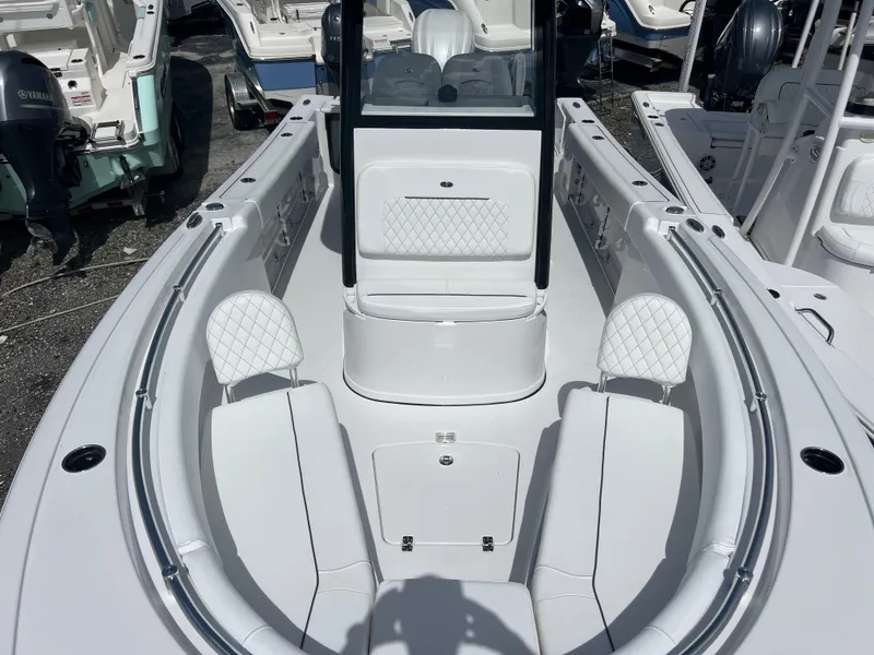 Slide: The Image of 2025 Sportsman Open 232 Center Console boat with white seating and sleek design. - 13