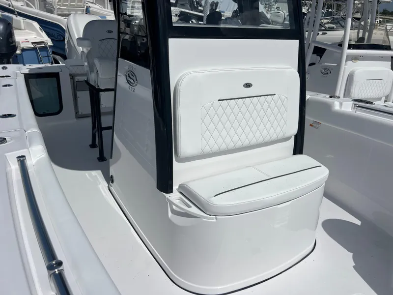 Slide: The Image of 2025 Sportsman Open 232 Center Console boat with white seating and sleek design. - 14