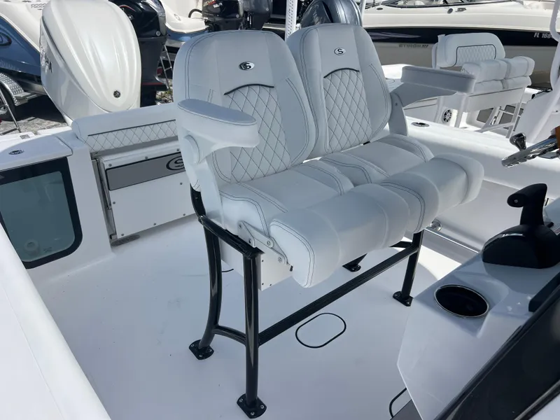 Slide: The Image of 2025 Sportsman Open 232 Center Console boat with white cushioned seating and sleek design. - 15