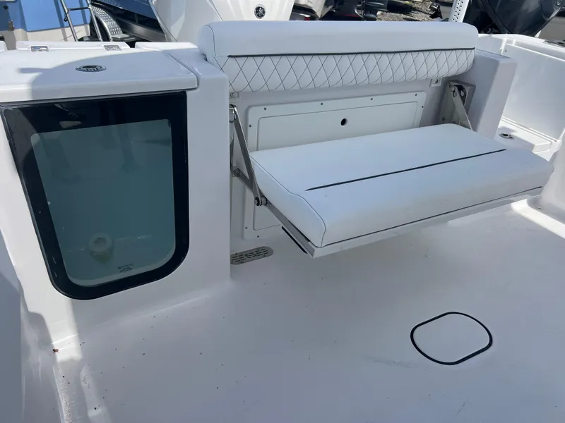 Slide: The Image of 2025 Sportsman Open 232 Center Console boat with foldable seating and storage compartment. - 17