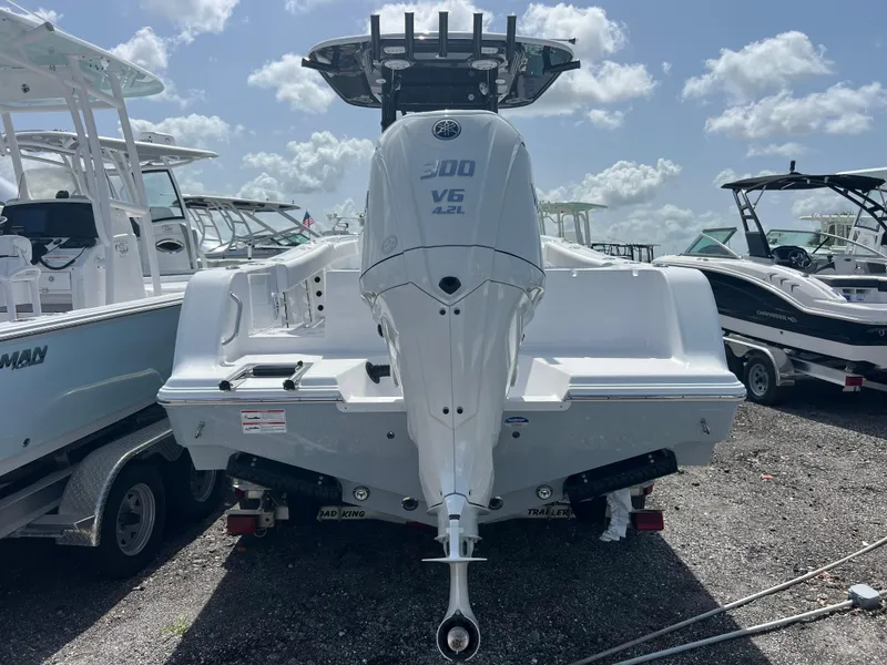 Slide: The Image of 2025 Sportsman Open 232 Center Console boat with powerful V6 engine, docked under a sunny sky. - 4