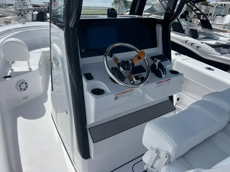Slide: The Image of 2025 Sportsman Open 232 Center Console boat interior with steering wheel and seating. - 8