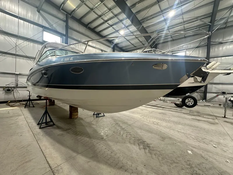 Slide: The Image of 2018 Formula 310 Sun Sport boat in storage facility, elevated on stands. - 1