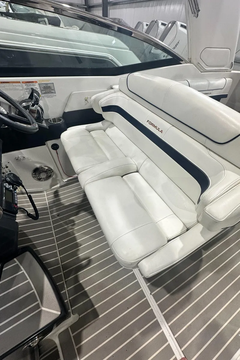 Slide: The Image of 2018 Formula 310 Sun Sport boat interior with white seating and sleek design. - 5
