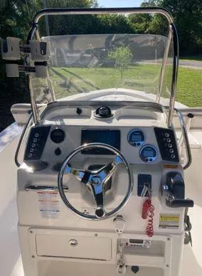 Slide: The Image of 2016 Robalo 206 Cayman boat dashboard with steering wheel and control panel. - 13