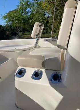 Slide: The Image of 2016 Robalo 206 Cayman boat seating with rod holders, outdoor setting. - 14