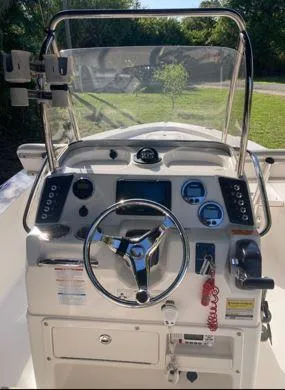 Slide: The Image of 2016 Robalo 206 Cayman boat dashboard with steering wheel and control panel. - 2
